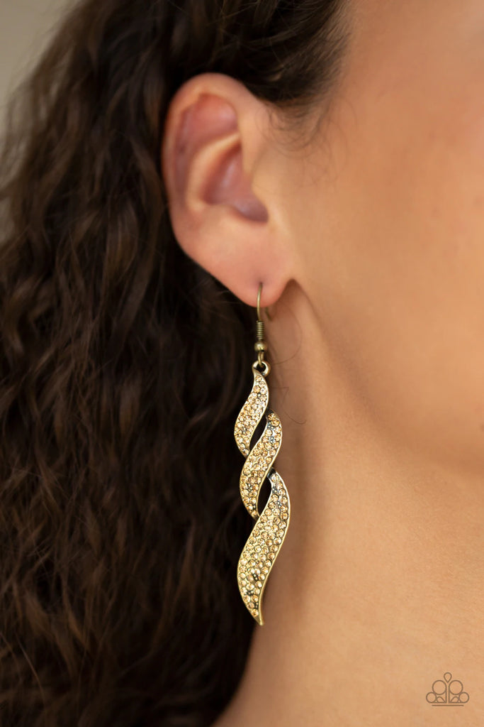 Dripping in golden topaz rhinestones, glistening brass ribbons overlap into a flame-like lure for a refined flair. Earring attaches to a standard fishhook fitting.  Sold as one pair of earrings.