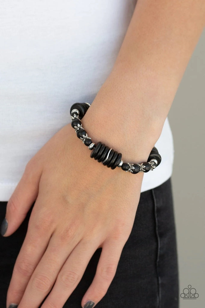 Featuring glistening silver accents, disc-shaped and round black stone beads are threaded along a stretchy band for a seasonal look.  Sold as one individual bracelet.