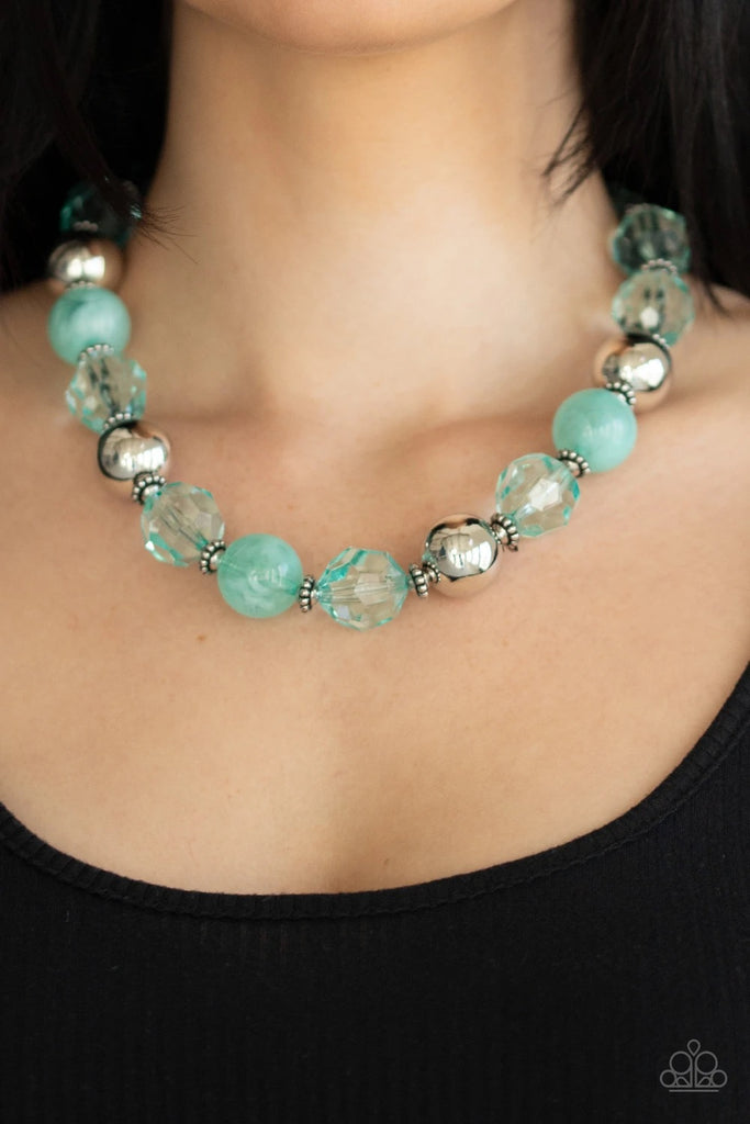 Infused with dainty silver accents, exaggerated display of oversized silver beads, faceted Biscay Green crystal-like beads, and cloudy Biscay Green beads are threaded along an invisible wire below the collar for a colorfully statement-making fashion. Features an adjustable clasp closure.  Sold as one individual necklace. Includes one pair of matching earrings.