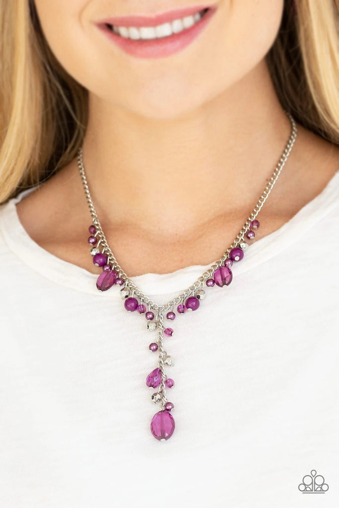 Mismatched polished purple beads, crystal-like beads, and faceted silver beads dance along a shimmery silver chain. Matching beading trickles along a single silver chain, creating a romantic extended pendant below the collar. Features an adjustable clasp closure.  Sold as one individual necklace. Includes one pair of matching earrings.