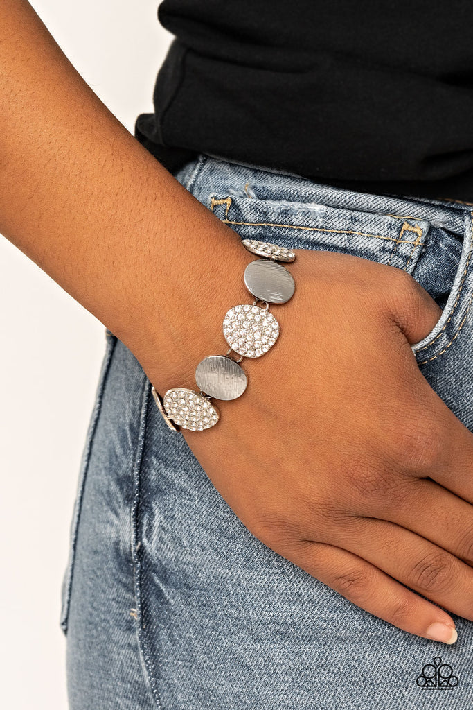 Featuring imperfect oval shapes, a series of delicately scratched and white rhinestone encrusted frames alternate around the wrist for a refined flair. Features an adjustable clasp closure.  Sold as one individual bracelet.