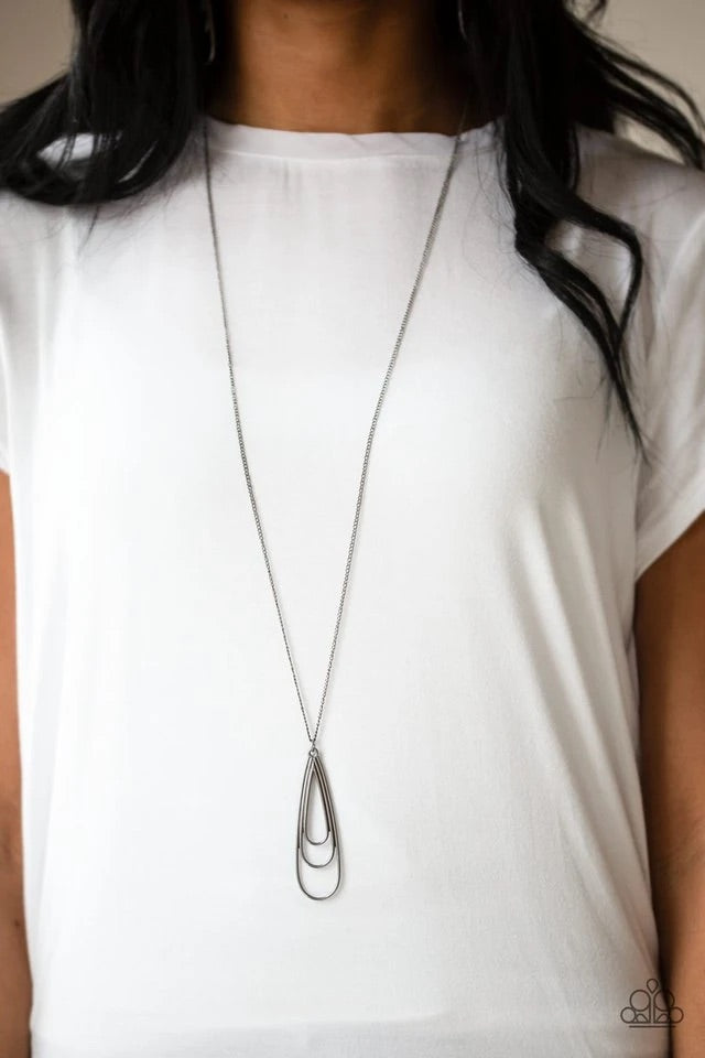 Gradually increasing in size, glistening gunmetal teardrops coalesce into a rippling frame for an edgy look. The airy pendant swings from the bottom of a lengthened gunmetal chain for an edgy look. Features an adjustable clasp closure. Sold as one individual necklace. Includes one pair of matching earrings.