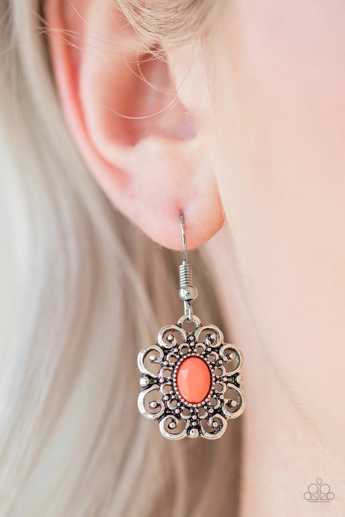 A faceted orange bead is pressed into the center of a frilly floral frame for a whimsical look. Earring attaches to a standard fishhook fitting.  Sold as one pair of earrings.
