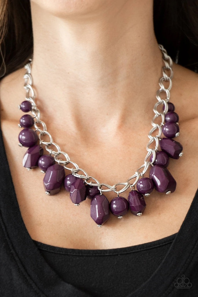 Varying in shape and shimmer, smooth and faceted purple beads trickle from doubled silver chain links, creating a colorful fringe below the collar. Features an adjustable clasp closure.  Sold as one individual necklace. Includes one pair of matching earrings.  