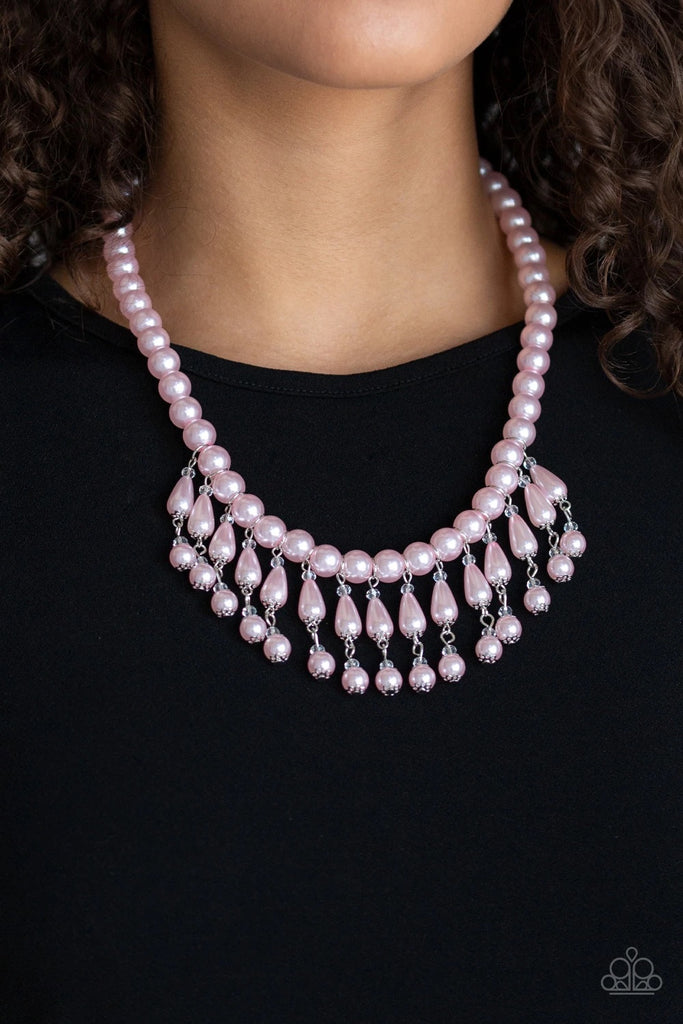 Pearly pink teardrop beads link with classic pink pearls as they drip from a timeless strand of pink pearls. Sprinkled with dainty crystal-like accents, the refined fringe cascades below the collar for a glamorous finish. Features an adjustable clasp closure.  Sold as one individual necklace. Includes one pair of matching earrings.