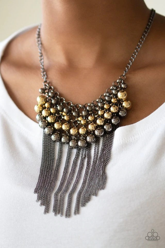 Gradually increasing in size, glistening gold and gunmetal beads swing from a net of interlocking gunmetal links. Shimmery gunmetal chains stream from the bottom of the beaded fringe for an edgy finish. Features an adjustable clasp closure. Sold as one individual necklace. Includes one pair of matching earrings.