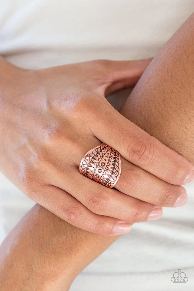 Stamped in tribal inspired patterns, a thick copper band curls around the finger for a seasonal look. Features a stretchy band for a flexible fit.  Sold as one individual ring.