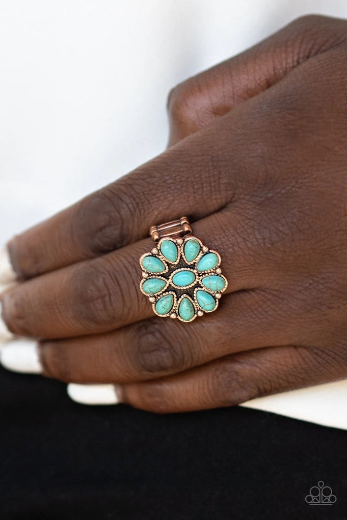 Featuring oval and teardrop shapes, refreshing turquoise stones are pressed into a studded copper frame, creating an earthy flower atop the finger. Features a stretchy band for a flexible fit.  Sold as one individual ring.  