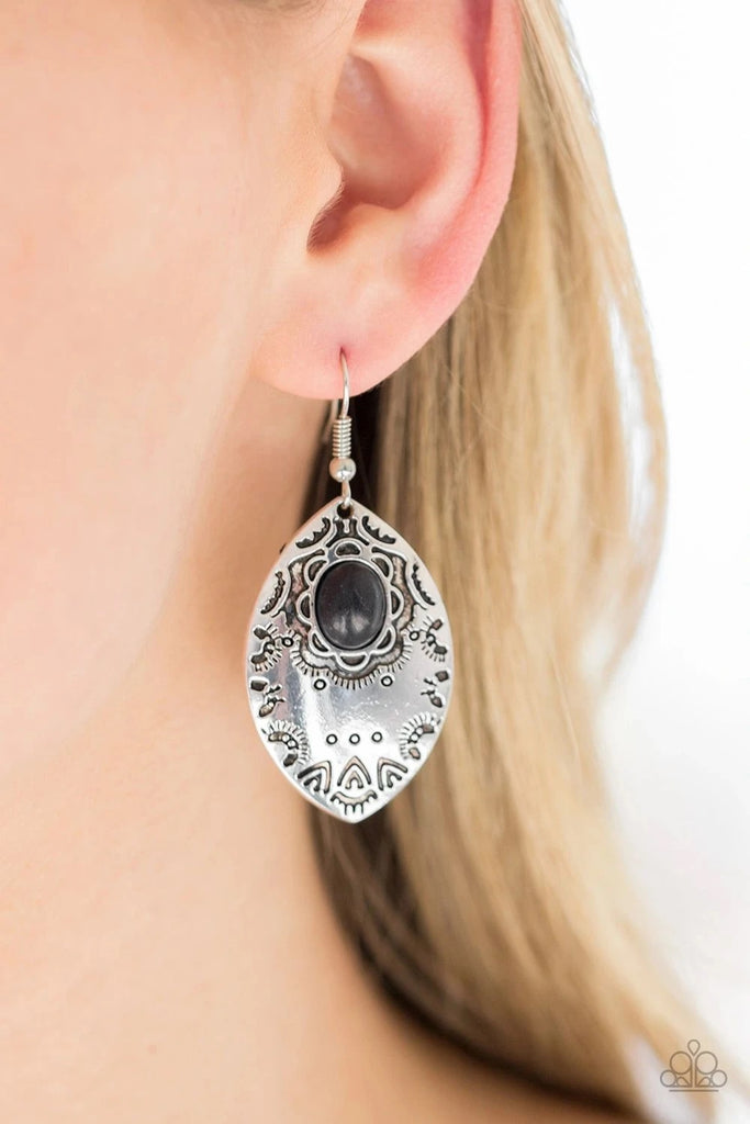 An earthy black stone is pressed into the center of a silver frame stamped with tribal inspired patterns for a seasonal look. Earring attaches to a standard fishhook fitting.      Sold as one pair of earrings.  