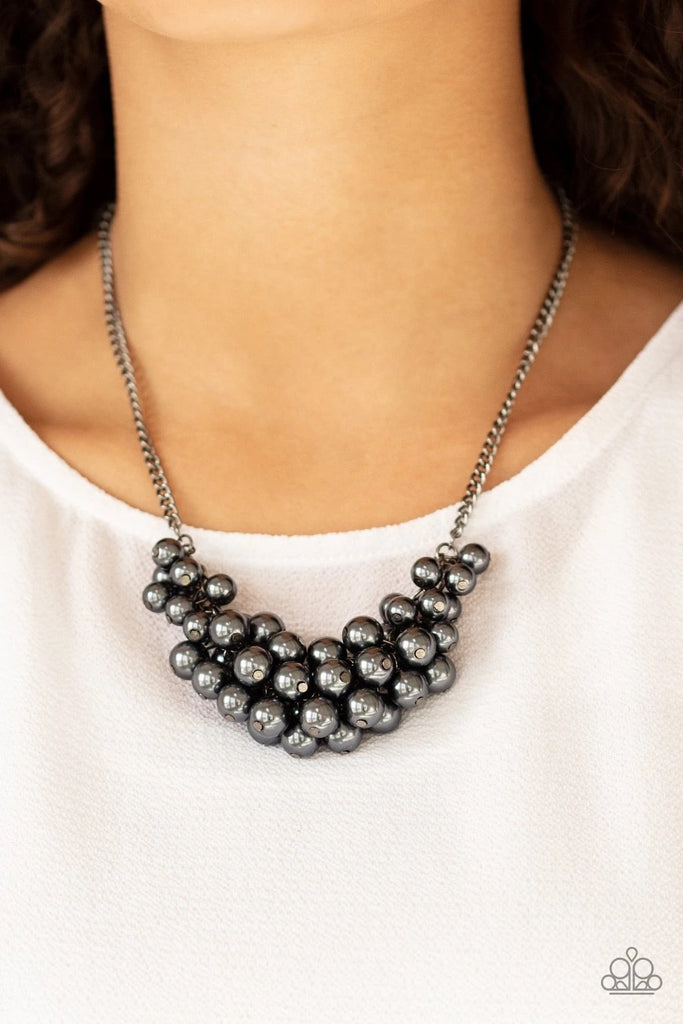 A collection of pearly gunmetal beads dangle from the bottom of a glistening gunmetal chain, creating a glamorously clustered display below the collar. Features an adjustable clasp closure.  Sold as one individual necklace. Includes one pair of matching earrings.