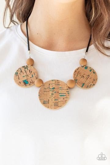 Featuring blue accents, cork-like frames and brown matte beads are threaded along an invisible wire below the collar for a statement-making look. Features an adjustable clasp closure.  Sold as one individual necklace. Includes one pair of matching earrings.
