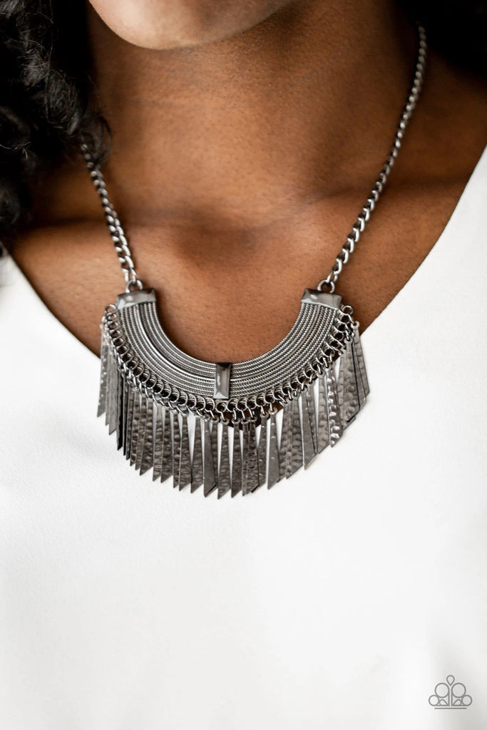Hammered in shimmery textures, flared gunmetal plates swing from the bottom of an ornate half-moon frame, creating an edgy fringe below the collar. Features an adjustable clasp closure.  Sold as one individual necklace. Includes one pair of matching earrings.