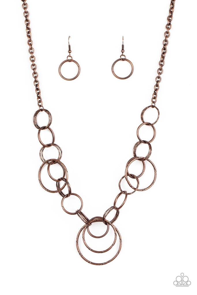 Varying in size and texture, a collision of antiqued copper rings link below the collar for a dizzying look. Features an adjustable clasp closure.  Sold as one individual necklace. Includes one pair of matching earrings.