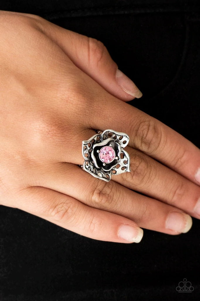 Featuring airy cut-out textures, antiqued silver petals gather around a glowing pink rhinestone center for a whimsical look. Features a stretchy band for a flexible fit.  Sold as one individual ring.
