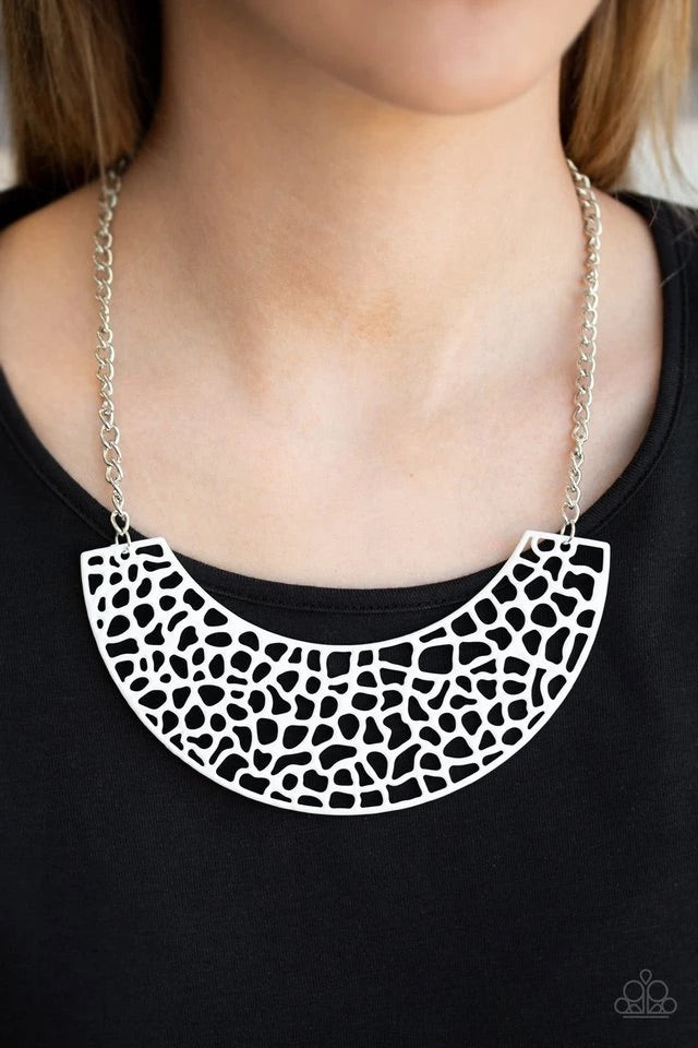 A large crescent shaped pendant is brushed in a brilliant white finish, creating a bold statement piece that lays along the collar as it swings from a shiny silver chain. Features an adjustable clasp closure. Sold as one individual necklace. Includes one pair of matching earrings.