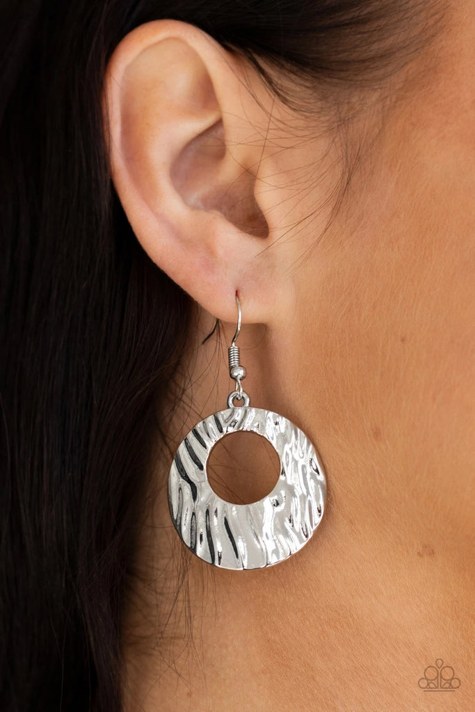 Rippling with texture, a beveled silver circular frame swings from the ear for a radiant look. Earring attaches to a standard fishhook fitting.  Sold as one pair of earrings.