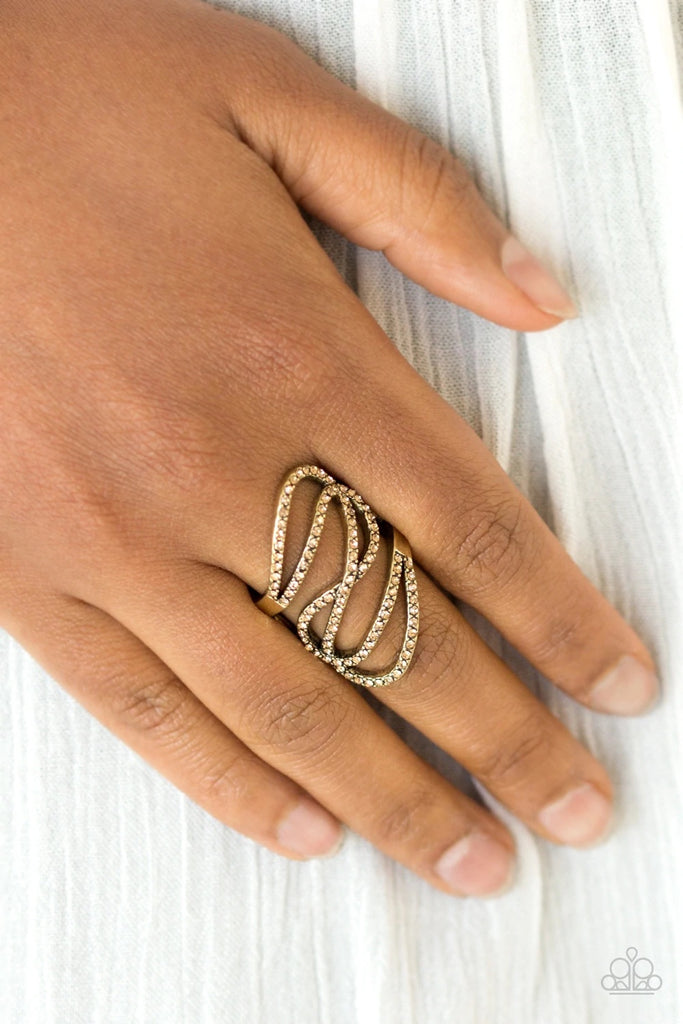Encrusted in golden topaz rhinestones, sparkling brass ribbons swoop across the finger for a refined look. Features a stretchy band for a flexible fit.  Sold as one individual ring.