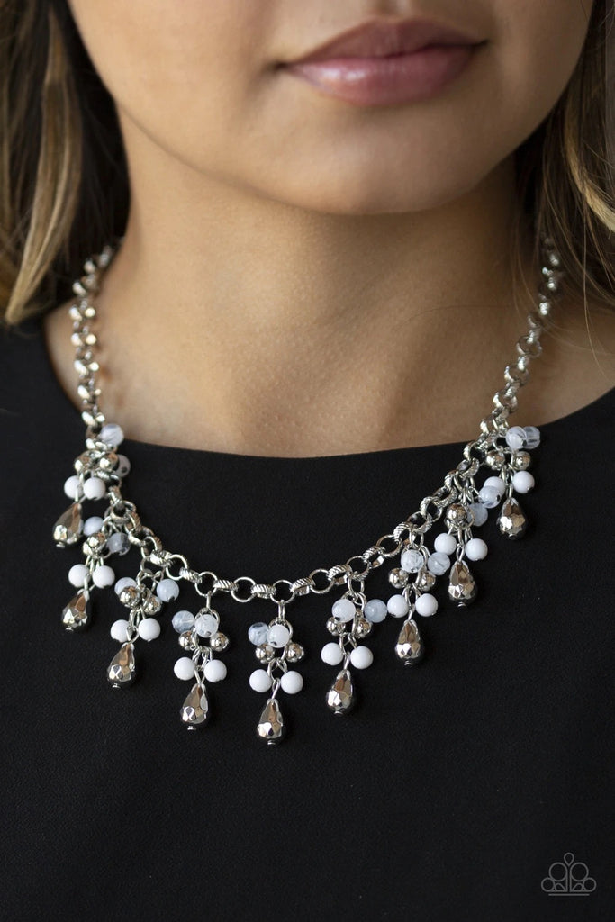 A collection of polished white, shiny silver, opaque beads, and faceted silver teardrops trickle from the bottom of a bold silver chain, creating a courageously clustered fringe below the collar. Features an adjustable clasp closure.  Sold as one individual necklace. Includes one pair of matching earrings.