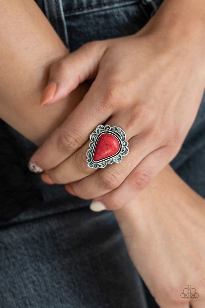 Chiseled into a tranquil teardrop, a fiery red stone is pressed into the center of the triangular silver frame bordered in a scalloped texture. Features a stretchy band for a flexible fit.  Sold as one individual ring.