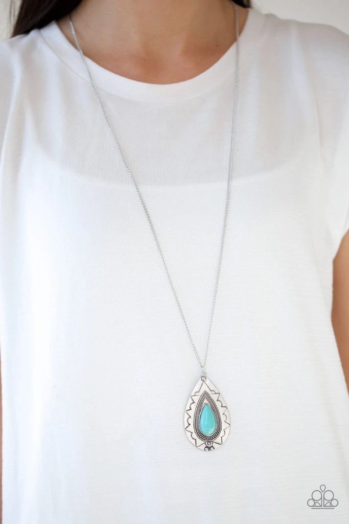 Chiseled into a tranquil teardrop, a refreshing turquoise stone is pressed into an ornate silver frame. The whimsical pendant swings from the bottom of a lengthened silver chain for a seasonal look. Features an adjustable clasp closure.  Sold as one individual necklace. Includes one pair of matching earrings.