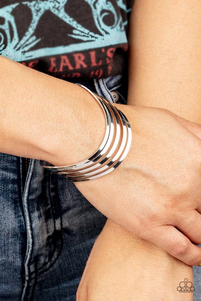 Layers of flat silver bars delicately curve in a wavy fashion across the wrist, coalescing into an airy cuff.  Sold as one individual bracelet.  