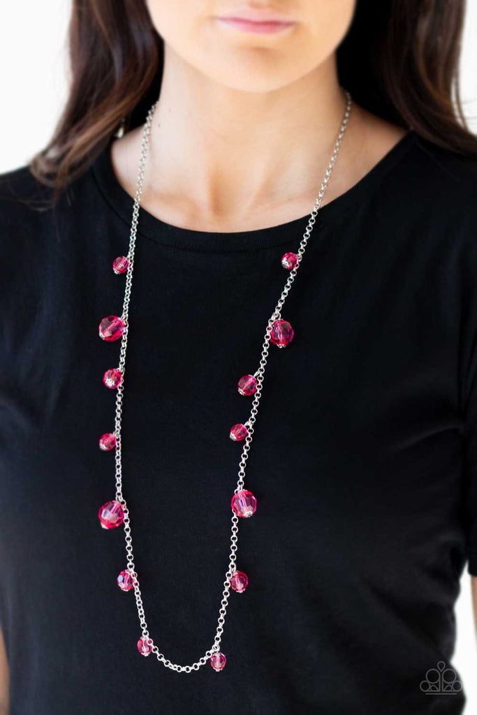 Varying in size, a collection of glassy pink crystal-like beads trickle down a shimmery silver chain across the chest for a whimsical look. Features an adjustable clasp closure.  Sold as one individual necklace. Includes one pair of matching earrings.