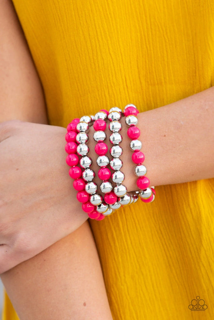 A bubbly collection of shiny silver and polished pink beads are threaded along stretchy bands around the wrist, creating colorful layers.  Sold as one set of five bracelets.