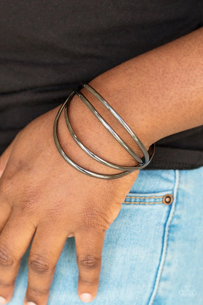 Glistening gunmetal bars arc across the wrist, coalescing into an airy cuff.  Sold as one individual bracelet.