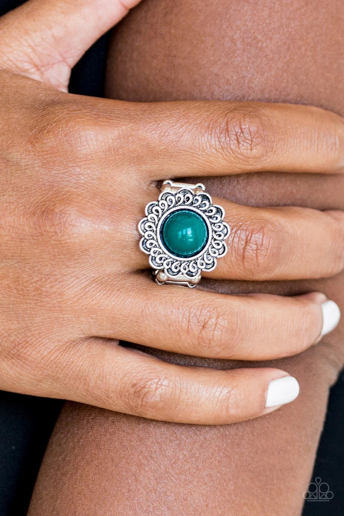 A refreshing green bead is pressed into the center of a shimmery floral frame radiating with swirling detail. Features a stretchy band for a flexible fit.  Sold as one individual ring.