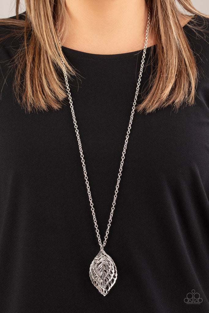 Gradually increasing in size, airy silver leaf pendants swing at the bottom of a lengthened silver chain, creating a seasonal pendant. Features an adjustable clasp closure.  Sold as one individual necklace. Includes one pair of matching earrings.