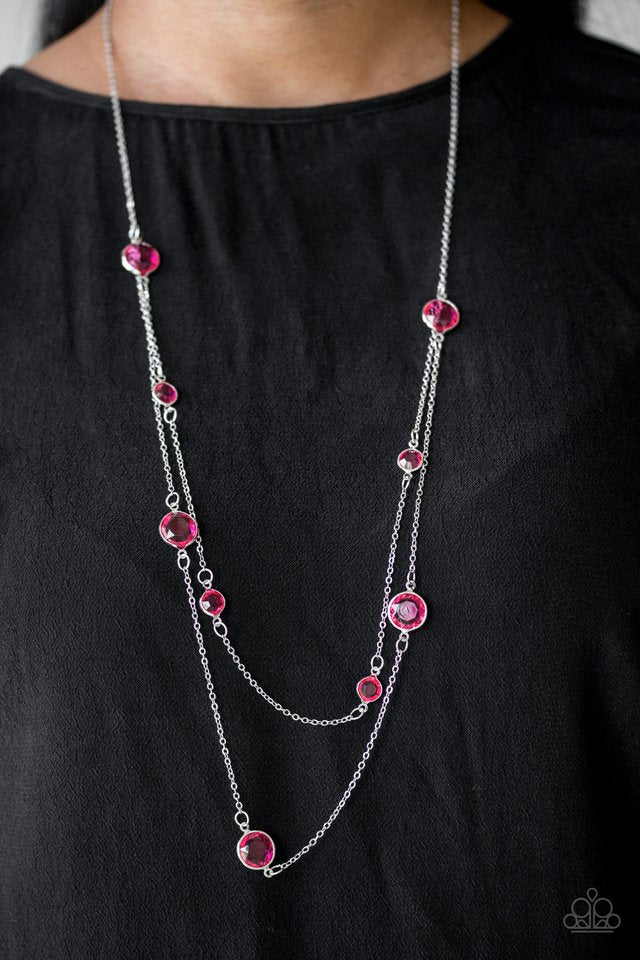 Varying in size, glassy pink gems trickle along dainty silver chains, creating sparkling layers across the chest. Features an adjustable clasp closure. Sold as one individual necklace. Includes one pair of matching earrings.