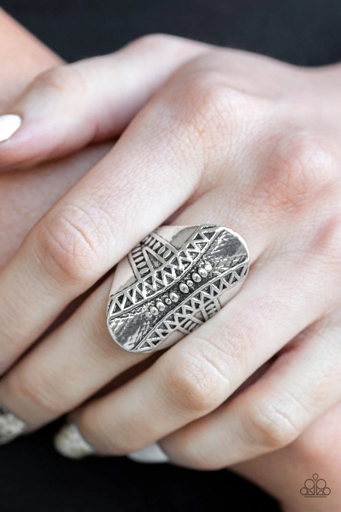 Studded and embossed in shimmery triangular patterns, a thick oval frame folds around the finger for a bold tribal look. Features a stretchy band for a flexible fit.  Sold as one individual ring.
