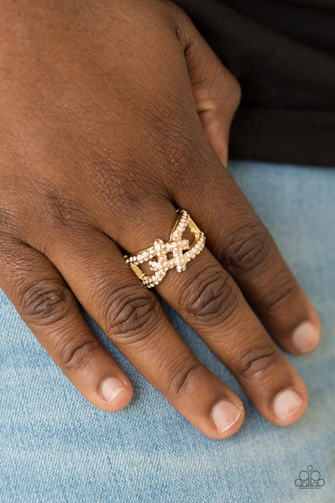 Encrusted in glittery white rhinestones, shimmery gold bars crisscross across the finger, coalescing into a bold square knot atop the finger. Features a stretchy band for a flexible fit.  Sold as one individual ring.