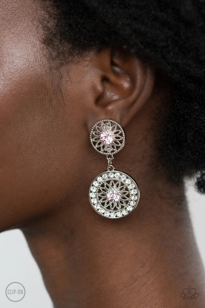 Dotted with glittery pink rhinestone centers, shimmery silver floral frames link into a whimsical lure. The lower frame is bordered in glassy white rhinestones for a timeless finish. Earring attaches to a standard clip-on fitting.  Sold as one pair of clip-on earrings.