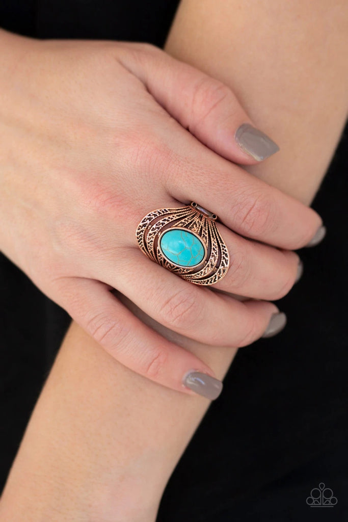 A refreshing turquoise stone is pressed into the center of layered copper bands radiating with tribal inspired textures for a seasonal look. Features a stretchy band for a flexible fit.  Sold as one individual ring.