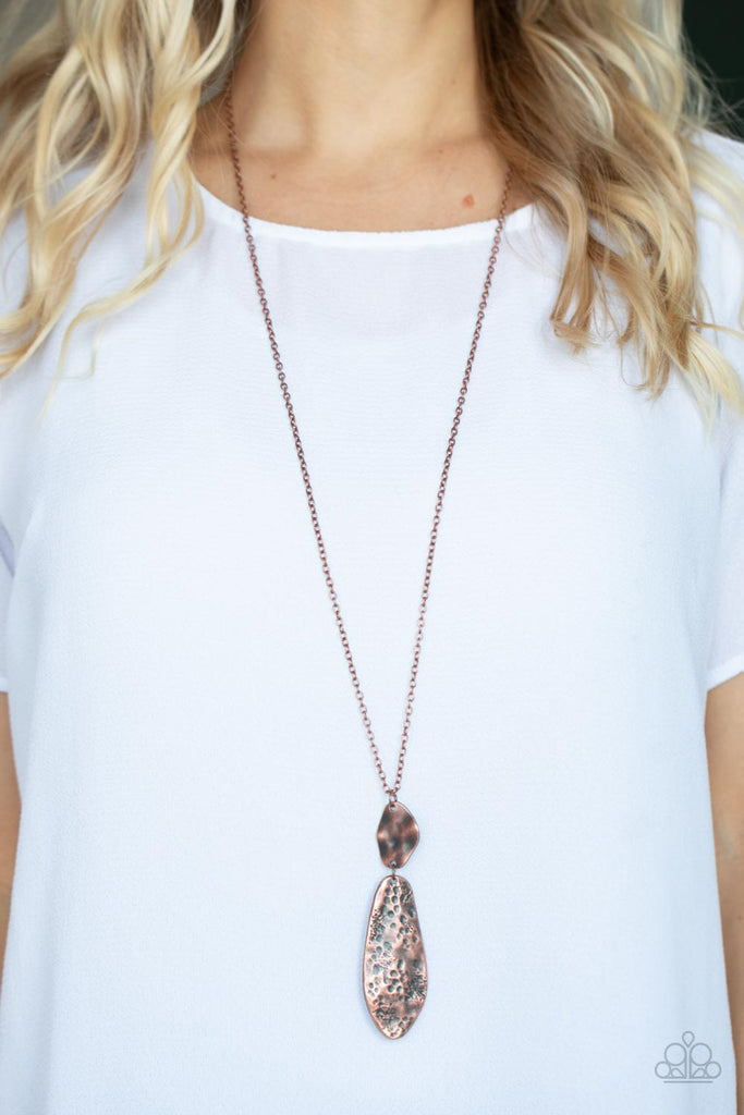 Hammered in bold rustic finishes, asymmetrical copper plates link at the bottom of a lengthened copper chain for an artisan inspired look. Features an adjustable clasp closure.  Sold as one individual necklace. Includes one pair of matching earrings.