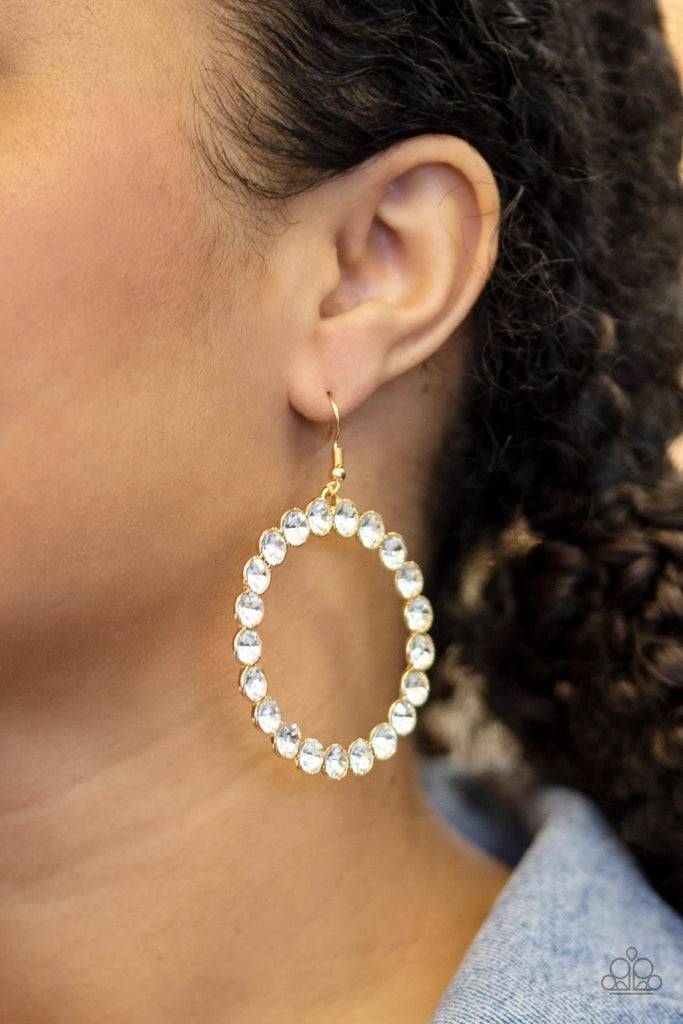 Featuring sleek gold fittings, oversized white rhinestones coalesce into a blinding hoop for a glamorous look. Earring attaches to a standard fishhook fitting.  Sold as one pair of earrings.