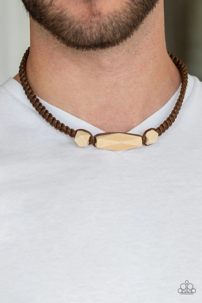 Shiny brown cording knots around geometric wooden beads, creating an edgy urban look below the collar. Features a button loop closure.  Sold as one individual necklace.