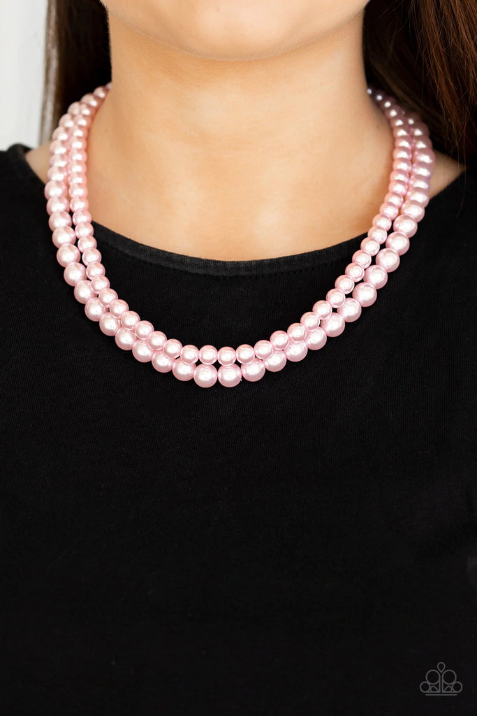 Two strands of classic pink pearls are strung along invisible wires below the collar. Each strand slightly varies in size, adding a modern twist to the timeless pearl palette. Features an adjustable clasp closure.  Sold as one individual necklace. Includes one pair of matching earrings.