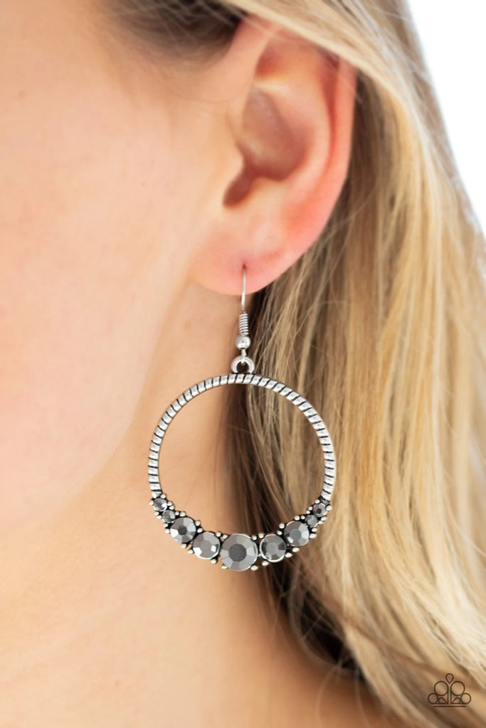 The bottom of a textured silver hoop is encrusted in glittery hematite rhinestones for a glamorous look. Earring attaches to a standard fishhook fitting.  Sold as one pair of earrings.