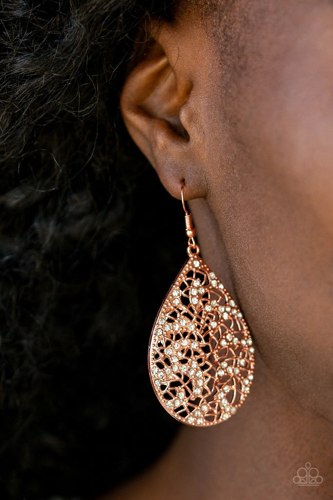 Dainty white rhinestones are sprinkled across a shiny copper teardrop radiating with stenciled filigree for a whimsical look. Earring attaches to a standard fishhook fitting.  Sold as one pair of earrings.