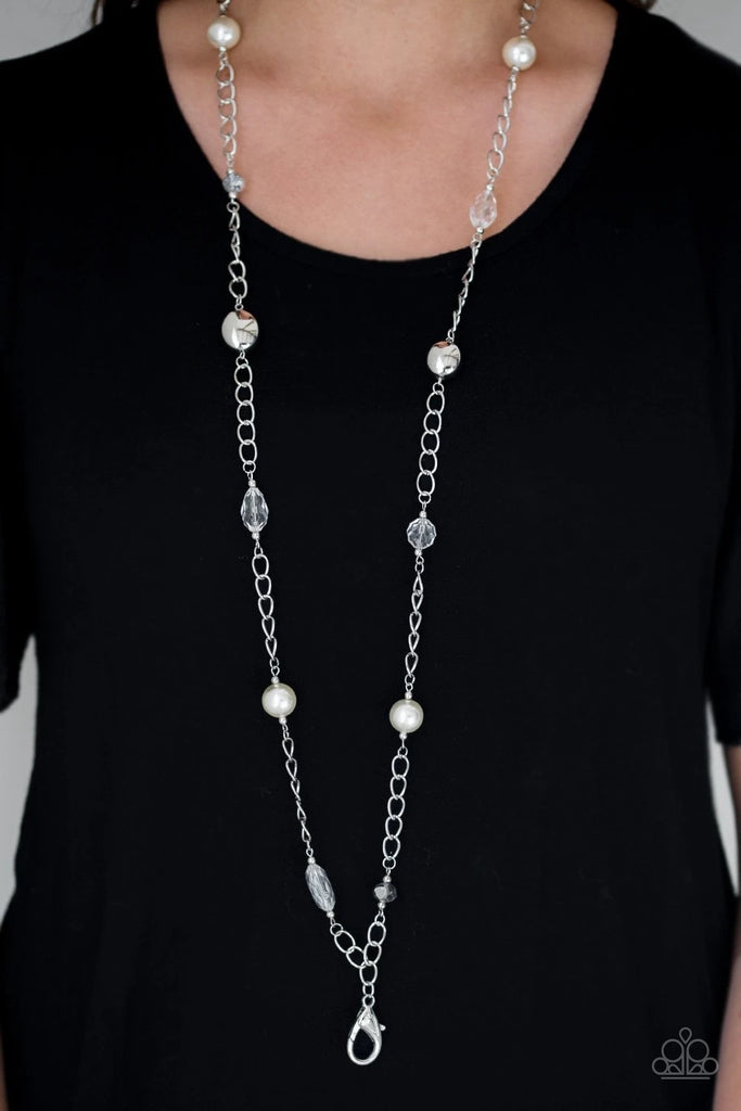 A collection of crystal-like, shiny silver, and pearly white beads trickle down a shimmery silver chain for a refined flair. A lobster clasp hangs from the bottom of the design to allow a name badge or other item to be attached. Features an adjustable clasp closure.  Sold as one individual lanyard. Includes one pair of matching earrings.