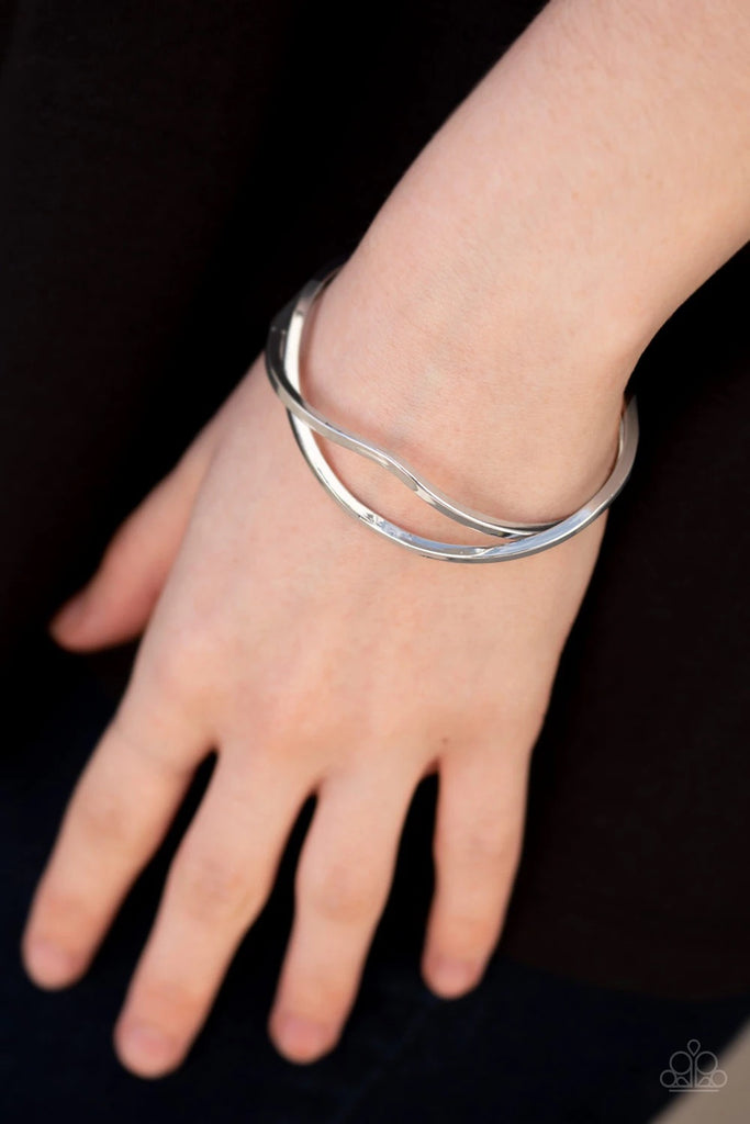 Glistening silver bars arc across the wrist, coalescing into an airy tribal cuff.  Sold as one individual bracelet.