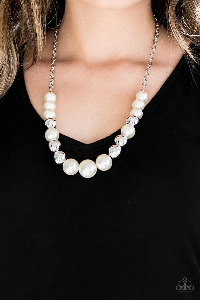 A collection of oversized silver and pearly white beads drape across the chest for a refined look. Features an adjustable clasp closure.  Sold as one individual necklace. Includes one pair of matching earrings.  