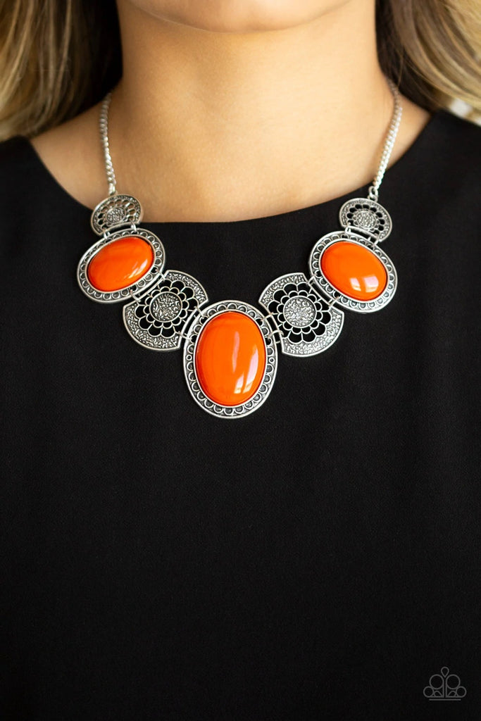 Flat orange beads connect with shimmery silver floral frames below the collar, creating a colorful medallion-like statement piece with a vintage inflection. Features an adjustable clasp closure.  Sold as one individual necklace. Includes one pair of matching earrings.  