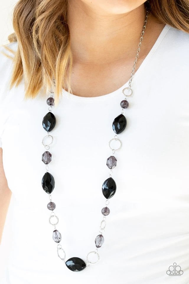 A collection of faceted, crystal-like, and sparkling black beads join across the chest. Hammered silver rings are sprinkled between the colorful accents for a whimsical finish. Features an adjustable clasp closure. Sold as one individual necklace. Includes one pair of matching earrings.