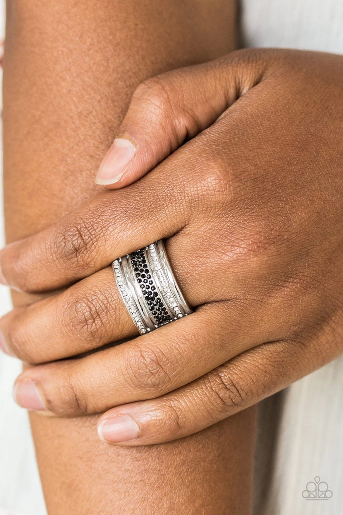 Black and white rhinestone encrusted bands stack across the finger for a glamorous look. Features a stretchy band for a flexible fit.  Sold as one individual ring.