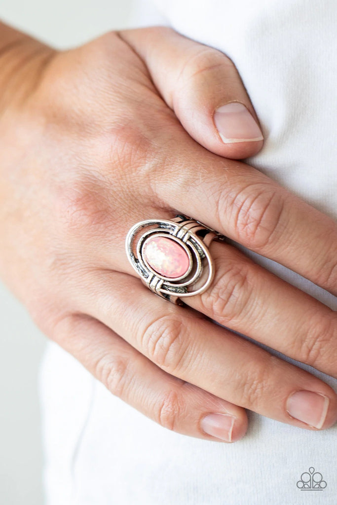 A sparkly pink opalescent bead is nestled between rippling silver ovals, creating an ethereal frame atop the finger. Features a stretchy band for a flexible fit.  Sold as one individual ring.