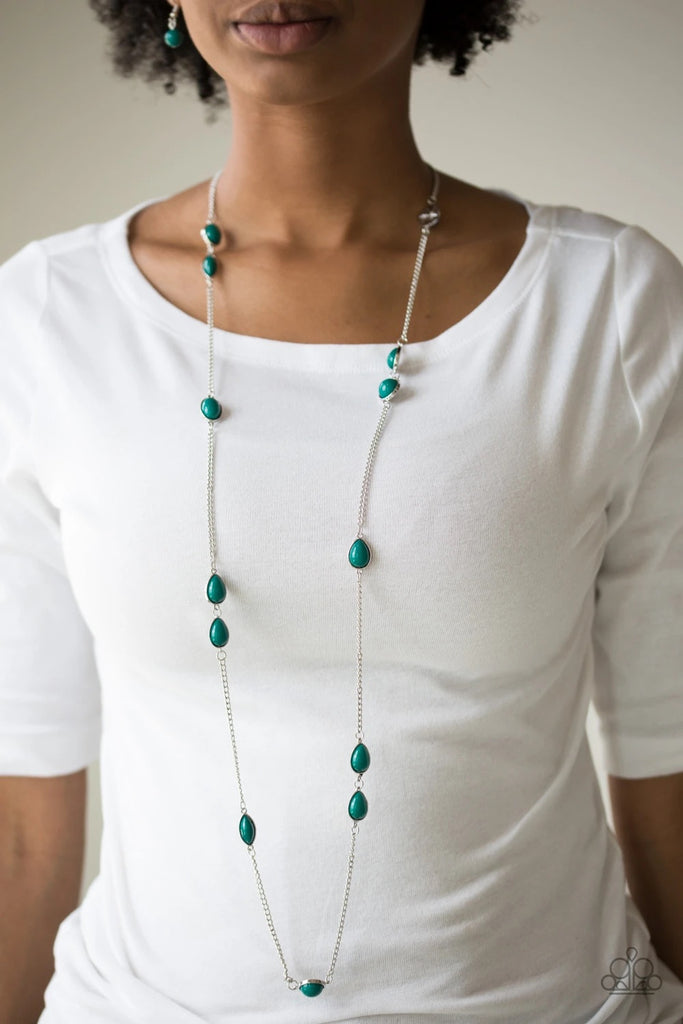 Featuring round and teardrop shapes, refreshing green beading trickles along an elongated silver chain for a seasonal look. Features an adjustable clasp closure.  Sold as one individual necklace. Includes one pair of matching earrings.