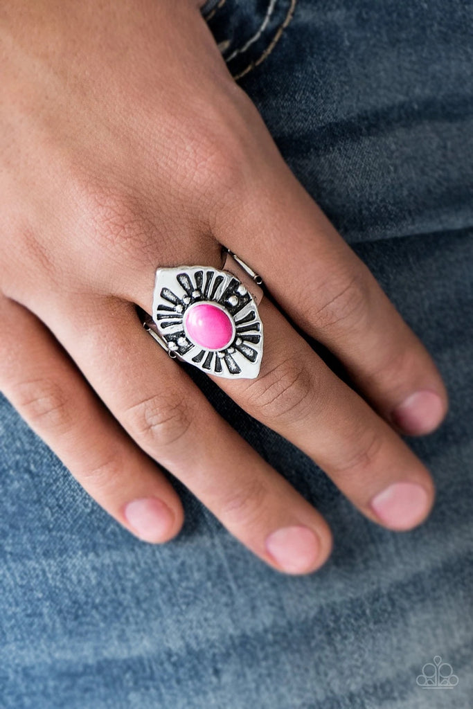 A vivacious pink stone bead is pressed into the center of an angular silver frame radiating with studded and antiqued textures. Features a stretchy band for a flexible fit.  Sold as one individual ring.
